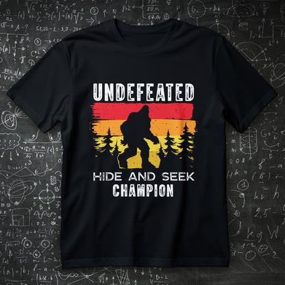 bigfoot hide and seek champion t-shirt - retro sunset forest silhouette funny cryptid tee