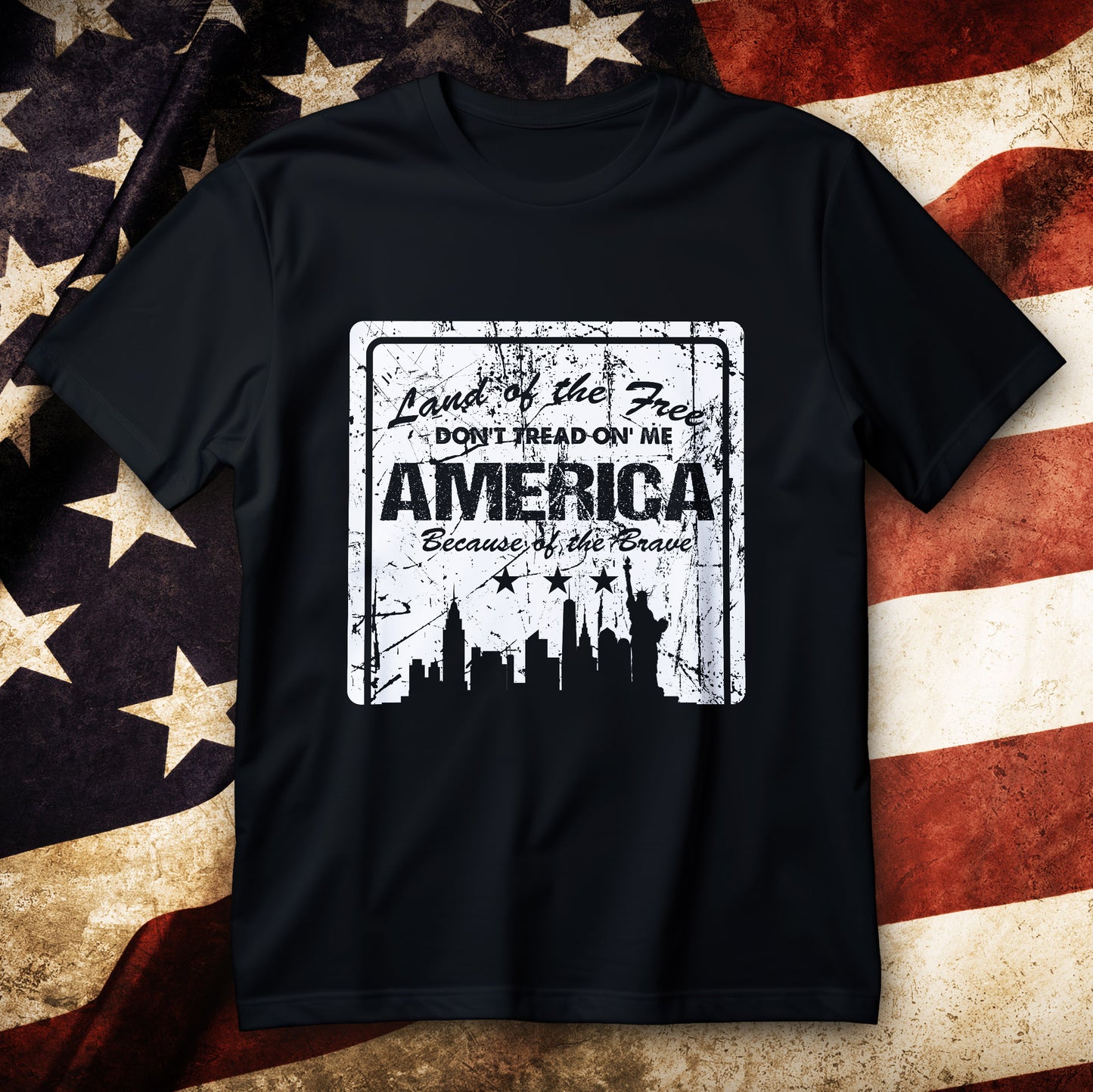 Distressed Statue of Liberty and NYC skyline graphic with “Land of the Free” slogans on a patriotic T-shirt.
